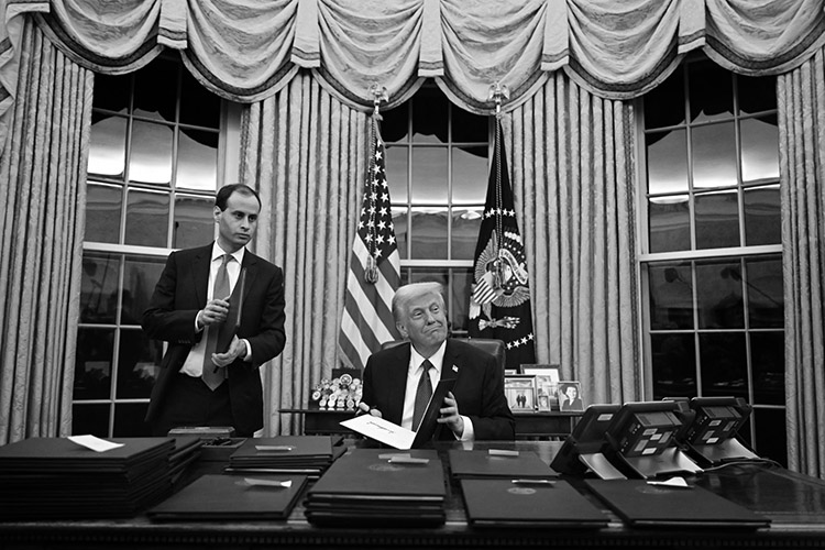  US President Donald Trump in the Oval Office in Washington, signing executive orders on 20 January. Image taken by Jim Watson / AFP